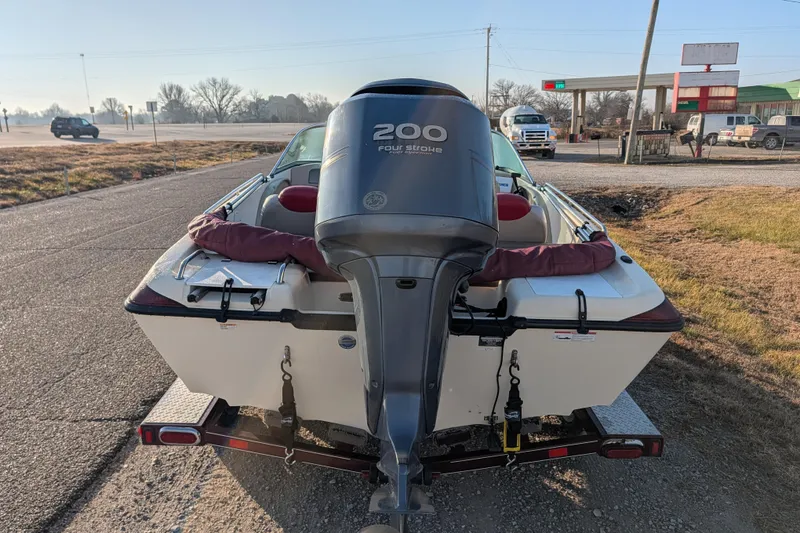 Slide: The Image of 2009 Skeeter SL1900 boat with 200 horsepower engine on trailer, parked roadside. - 6