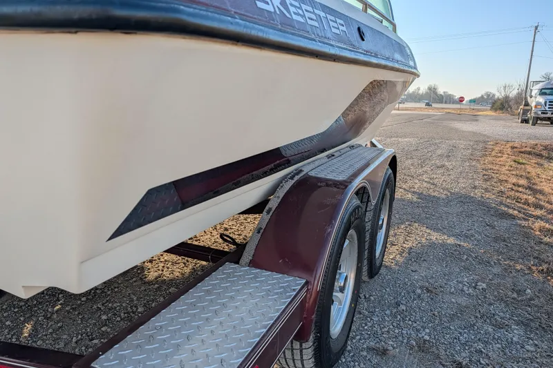 Slide: The Image of 2009 Skeeter SL1900 boat on trailer, side view on gravel road. - 7