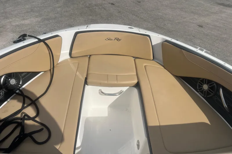 Slide: The Image of 2024 Sea Ray SPX 210 Outboard boat interior with tan seating and speaker system. - 4