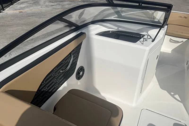 Slide: The Image of 2024 Sea Ray SPX 210 Outboard interior with tan seating and sleek design. - 5