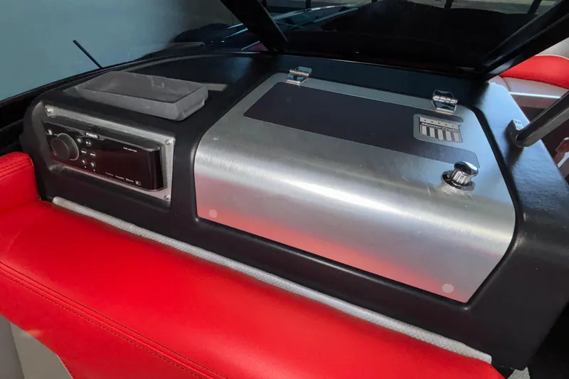 Slide: The Image of 2017 MasterCraft X46 dashboard with red seating and audio controls. - 13