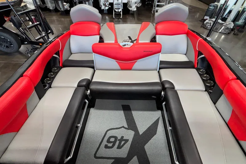 Slide: The Image of 2017 MasterCraft X46 boat interior with red, gray, and black seating, showcasing luxury design. - 17