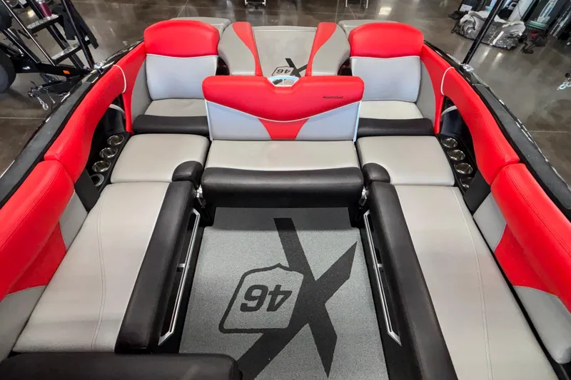 Slide: The Image of 2017 MasterCraft X46 boat interior with red and gray seating, showcasing luxury design. - 21
