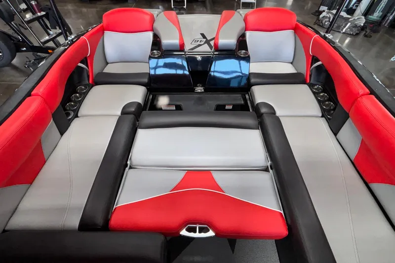 Slide: The Image of 2017 MasterCraft X46 boat interior with red, gray, and black seating. - 23