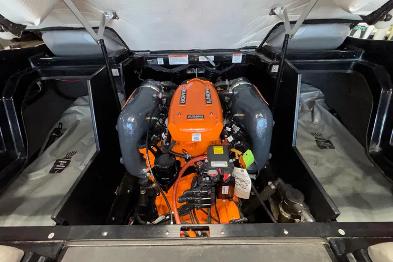 Slide: The Image of 2017 MasterCraft X46 engine compartment with vibrant orange engine components. - 24