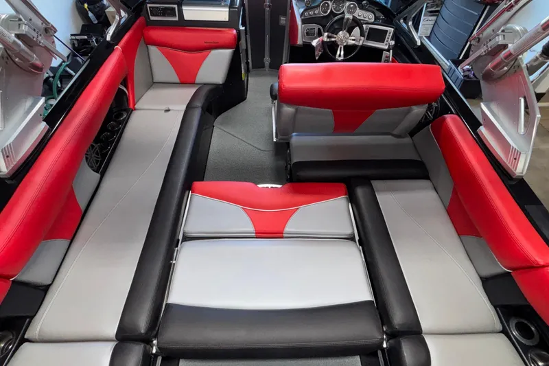 Slide: The Image of 2017 MasterCraft X46 interior with red and gray seating, modern dashboard, and spacious layout. - 26