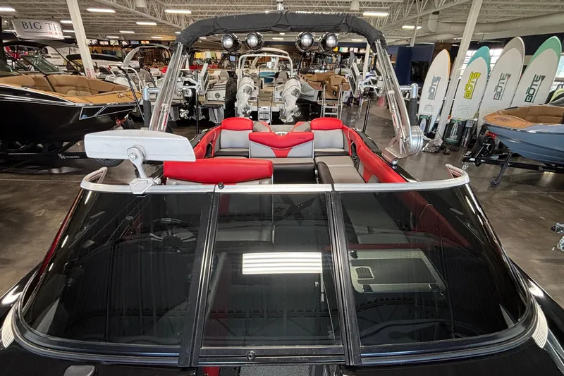Slide: The Image of 2017 MasterCraft X46 boat with red and gray interior in showroom. - 32