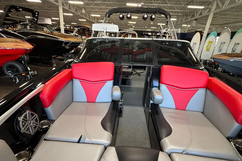 Slide: The Image of 2017 MasterCraft X46 boat interior with red and gray seating in showroom. - 33