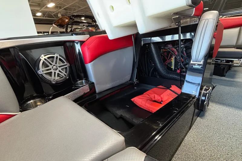 Slide: The Image of 2017 MasterCraft X46 interior showing speaker, wiring, and storage compartment with life jacket. - 35