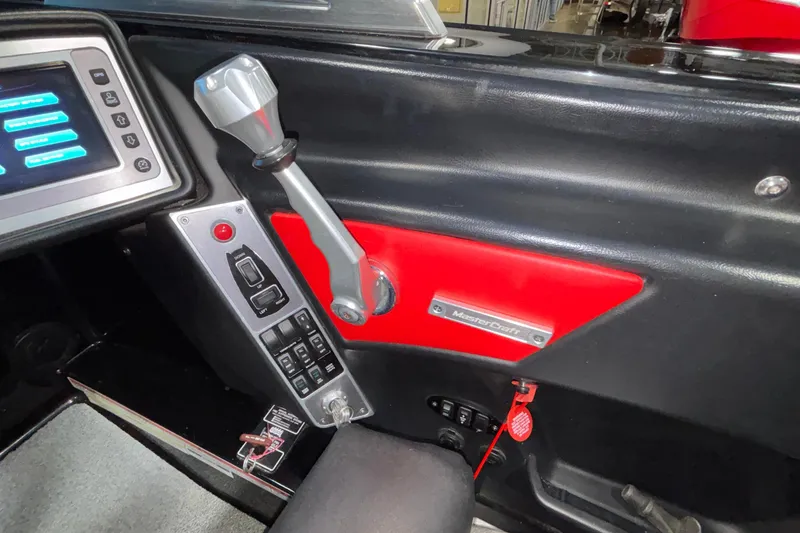 Slide: The Image of 2017 MasterCraft X46 boat dashboard with control panel and throttle lever. - 43