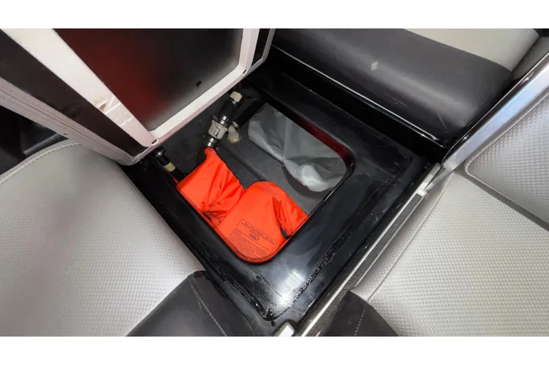 Slide: The Image of 2017 MasterCraft X46 storage compartment with orange life jackets. - 44
