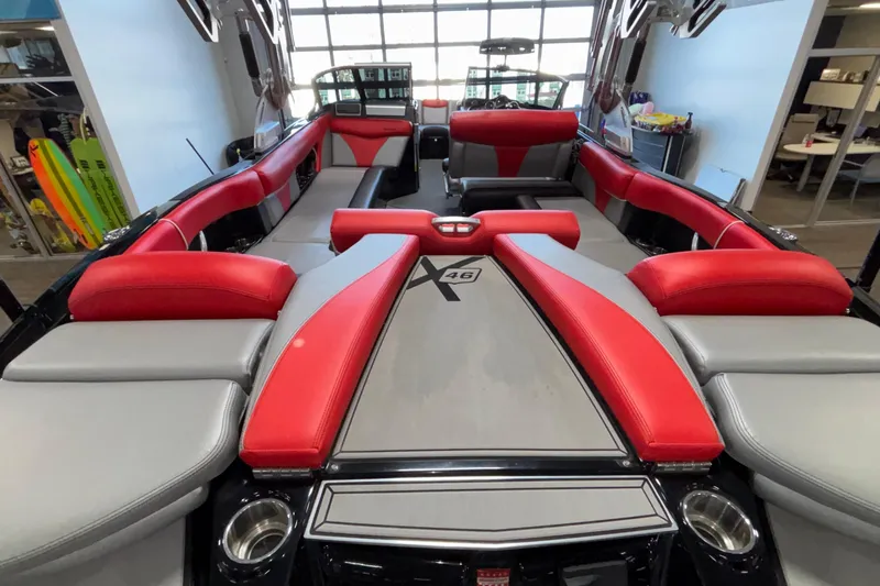 Slide: The Image of 2017 MasterCraft X46 boat interior with red and gray seating, showcasing spacious design. - 9