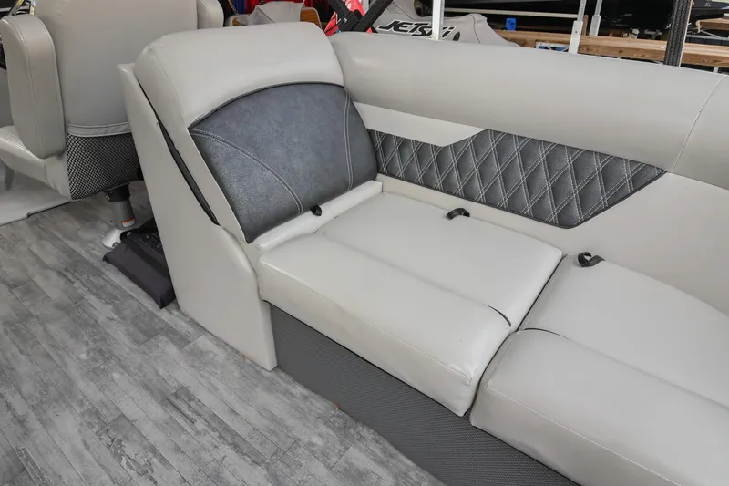 Slide: The Image of 2021 Crest Classic DLX 220 L boat interior with gray cushioned seating and diamond-patterned accents. - 20
