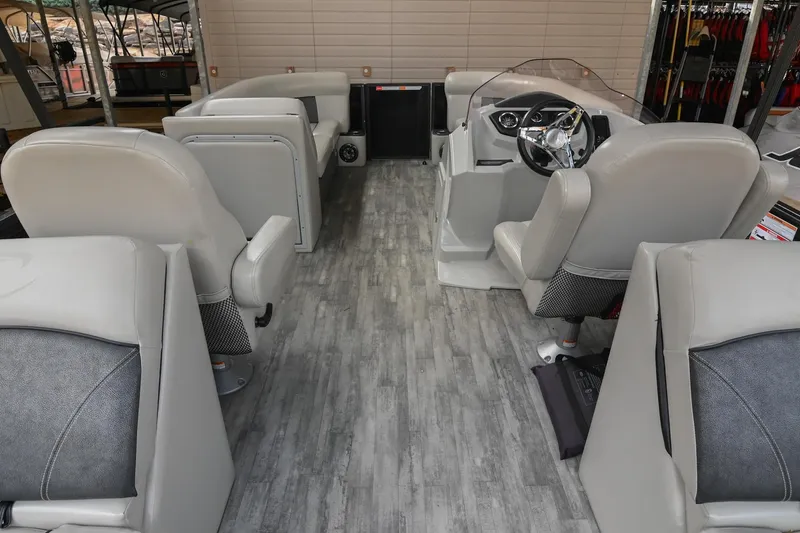 Slide: The Image of Interior of 2021 Crest Classic DLX 220 L pontoon boat with gray seating and modern dashboard. - 21