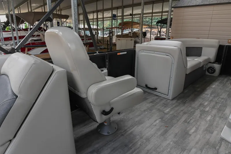 Slide: The Image of Interior of 2021 Crest Classic DLX 220 L pontoon boat with gray seating and flooring. - 22