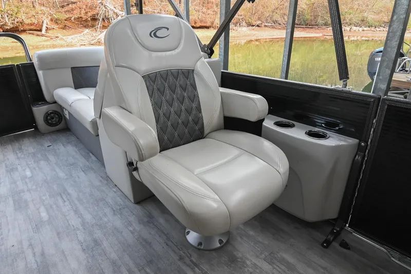 Slide: The Image of 2021 Crest Classic DLX 220 L boat interior with luxurious seating and cup holders. - 23