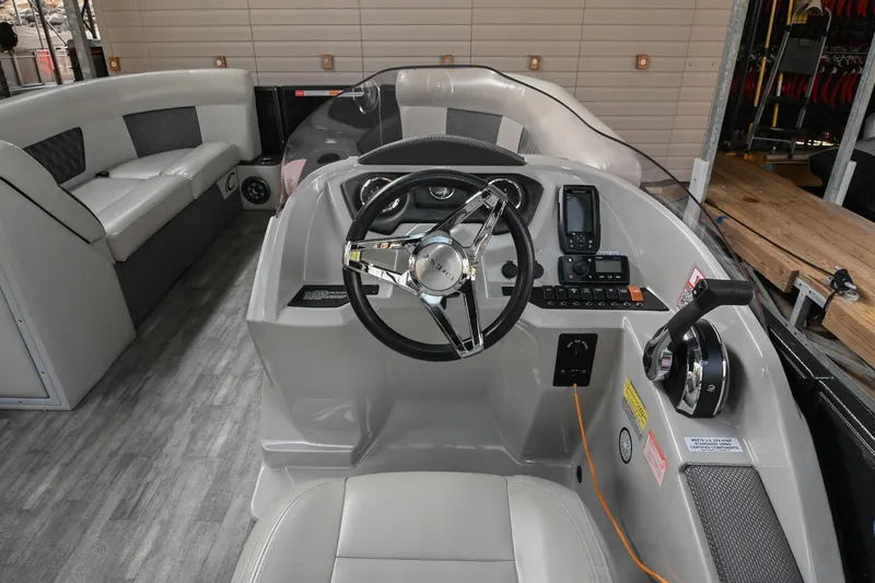 Slide: The Image of 2021 Crest Classic DLX 220 L boat interior with steering wheel and seating. - 25