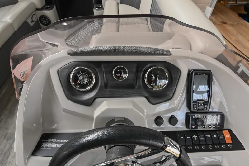 Slide: The Image of 2021 Crest Classic DLX 220 L dashboard with gauges and Garmin device. - 27