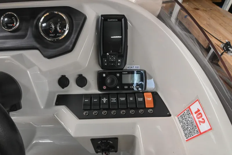 Slide: The Image of Control panel of 2021 Crest Classic DLX 220 L boat with gauges and switches. - 28