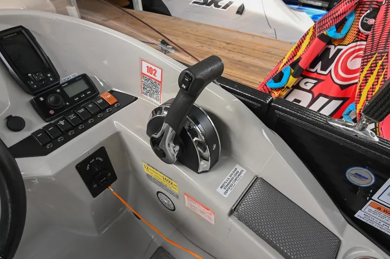 Slide: The Image of 2021 Crest Classic DLX 220 L boat dashboard with controls and colorful accessories. - 29