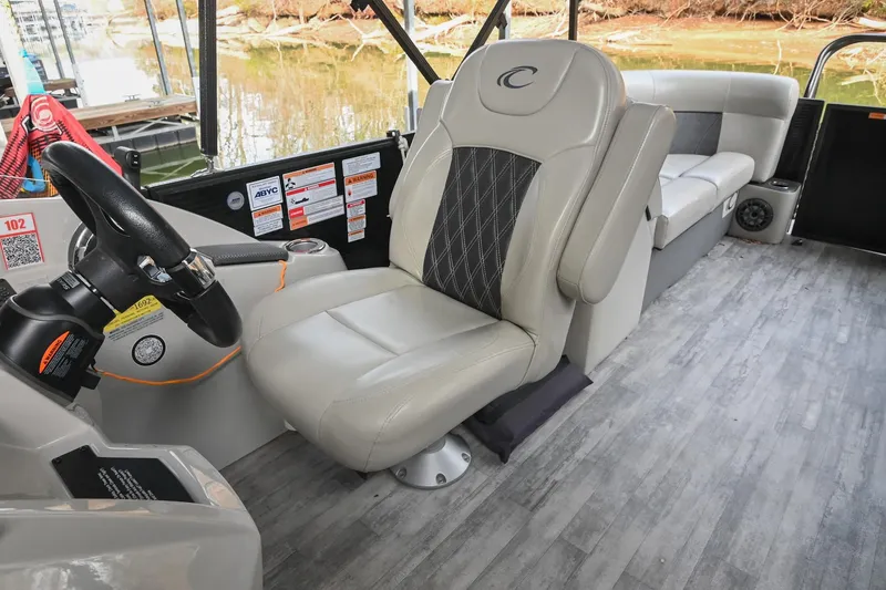 Slide: The Image of 2021 Crest Classic DLX 220 L boat interior with captain's chair and steering wheel. - 30