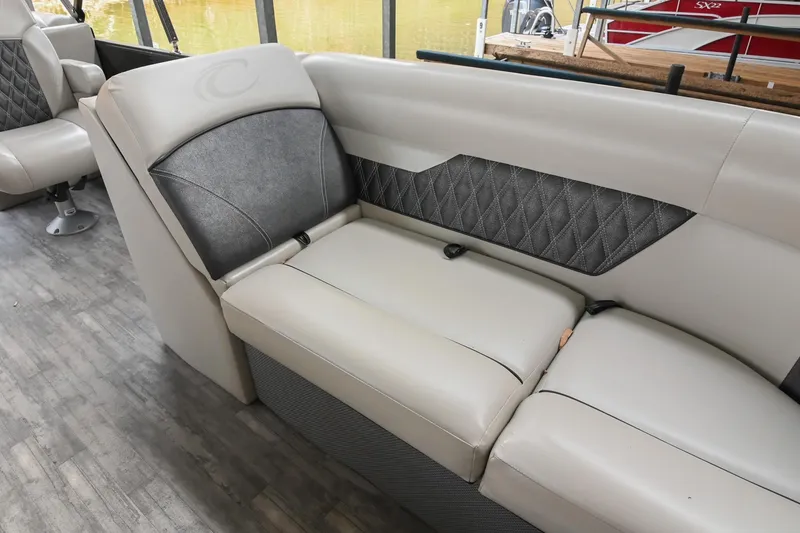 Slide: The Image of 2021 Crest Classic DLX 220 L boat interior with gray cushioned seating and diamond-patterned accents. - 35