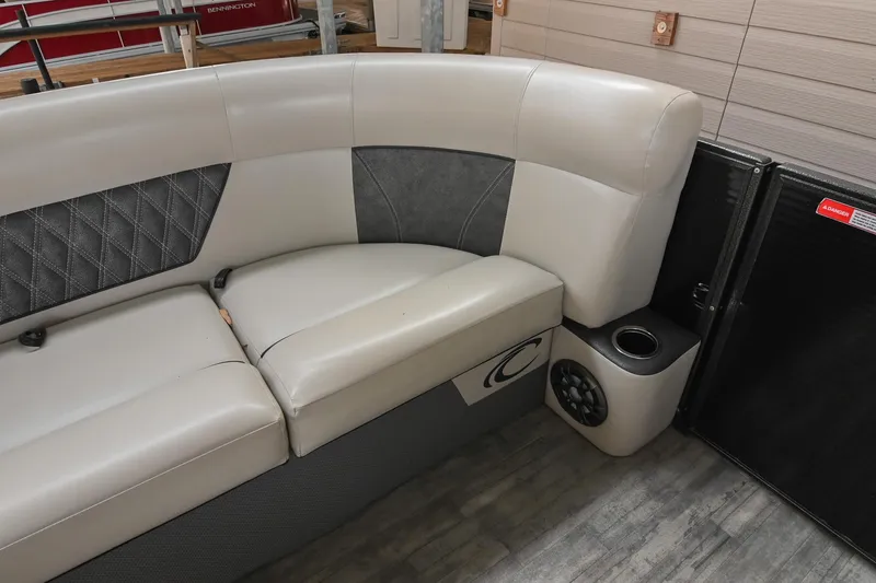 Slide: The Image of 2021 Crest Classic DLX 220 L boat interior with cushioned seating and speaker. - 36