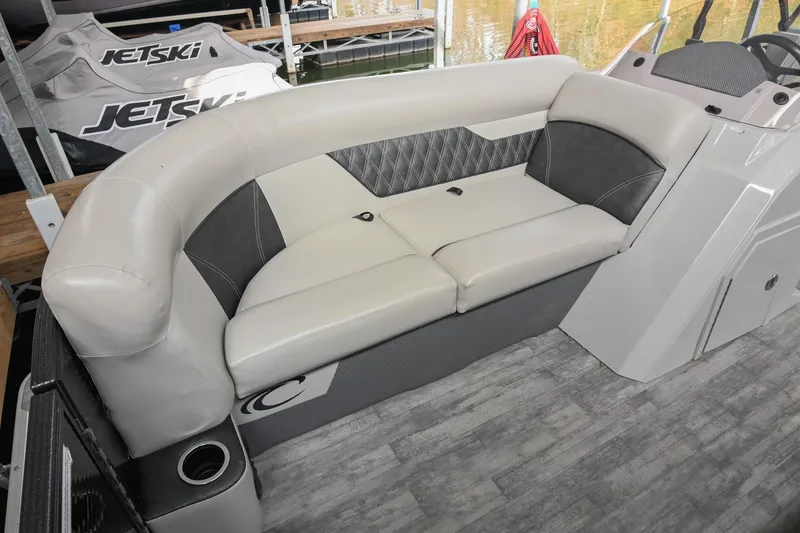 Slide: The Image of 2021 Crest Classic DLX 220 L boat interior with cushioned seating and modern design. - 38