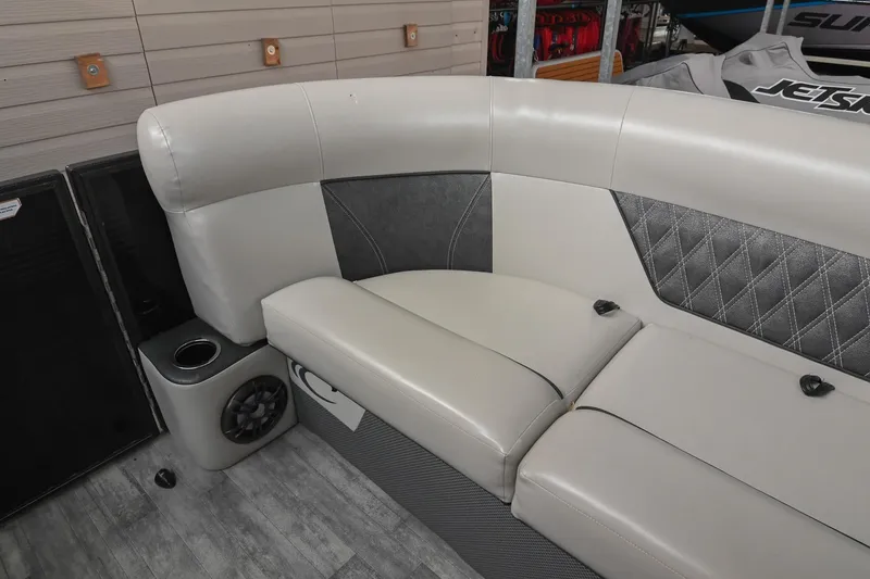 Slide: The Image of 2021 Crest Classic DLX 220 L boat interior with plush seating and speaker system. - 40