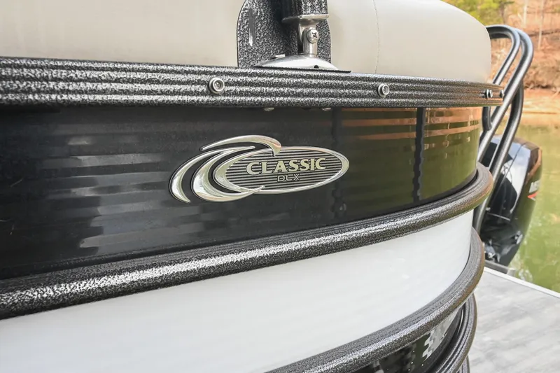 Slide: The Image of 2021 Crest Classic DLX 220 L pontoon boat with logo detail. - 6