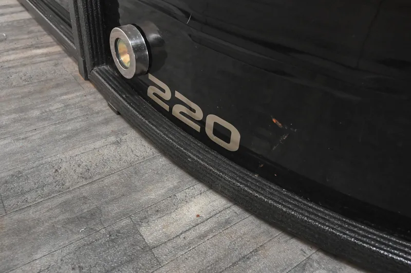 Slide: The Image of 2021 Crest Classic DLX 220 L boat detail with model number on black surface. - 7