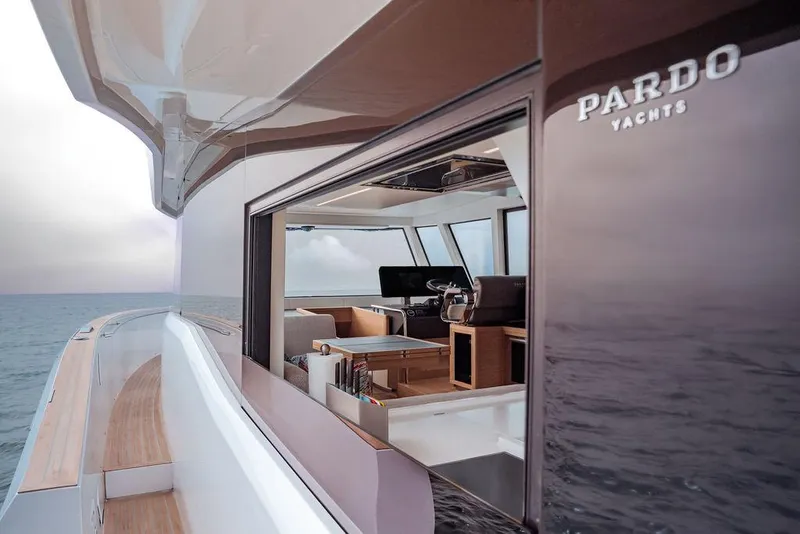 Slide: The Image of 2023 Pardo Yachts Endurance 60, luxury yacht interior view with ocean backdrop. - 12