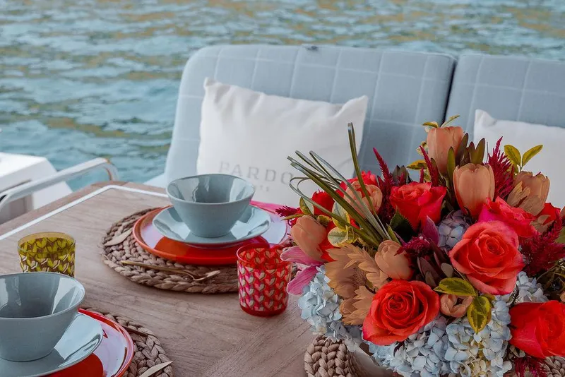 Slide: The Image of Elegant table setting on 2023 Pardo Yachts Endurance 60 with vibrant floral centerpiece. - 15