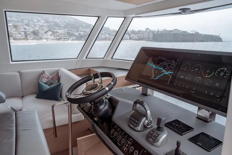 Slide: The Image of Helm of 2023 Pardo Yachts Endurance 60 with modern navigation system and coastal view. - 16