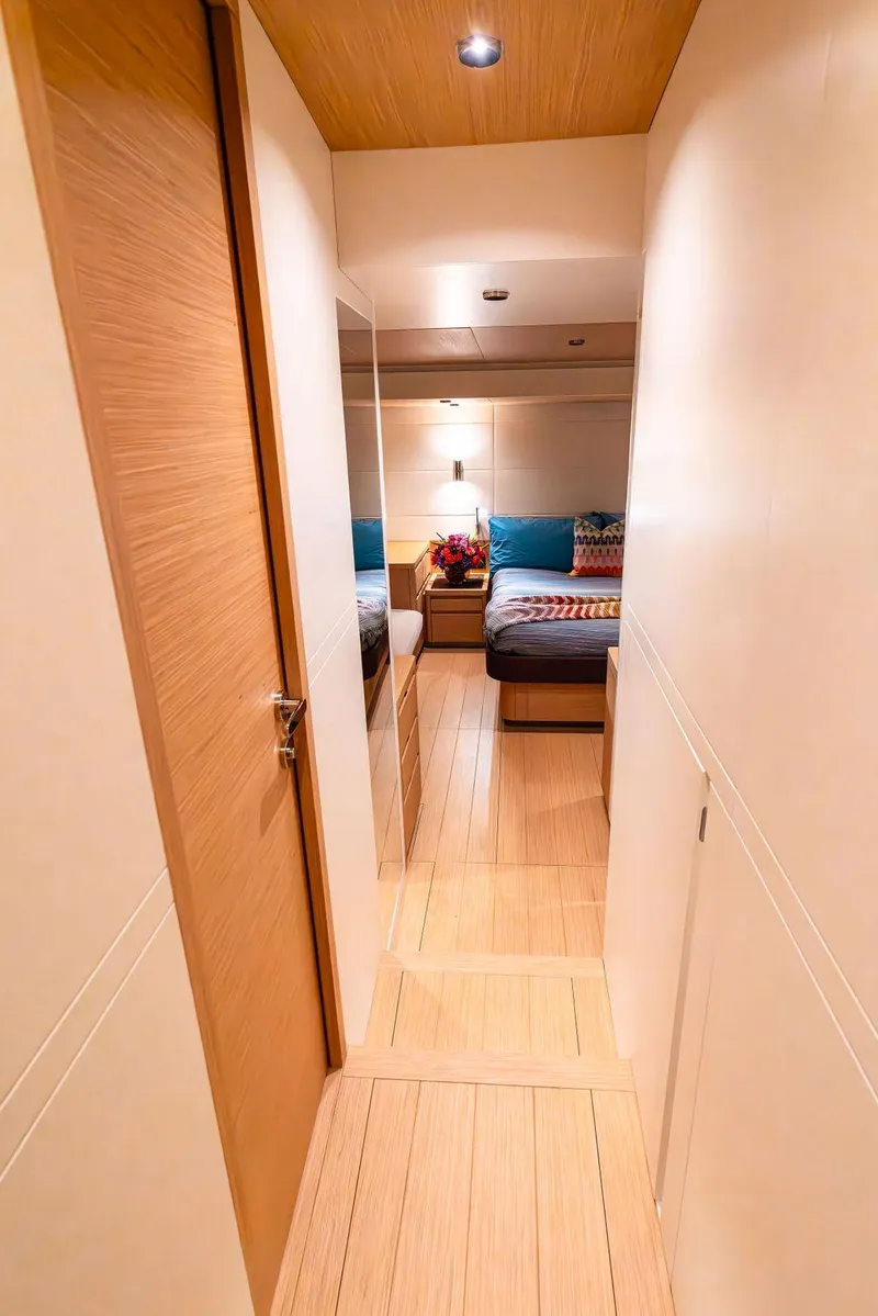 Slide: The Image of 2023 Pardo Yachts Endurance 60 interior hallway leading to a cozy bedroom. - 27
