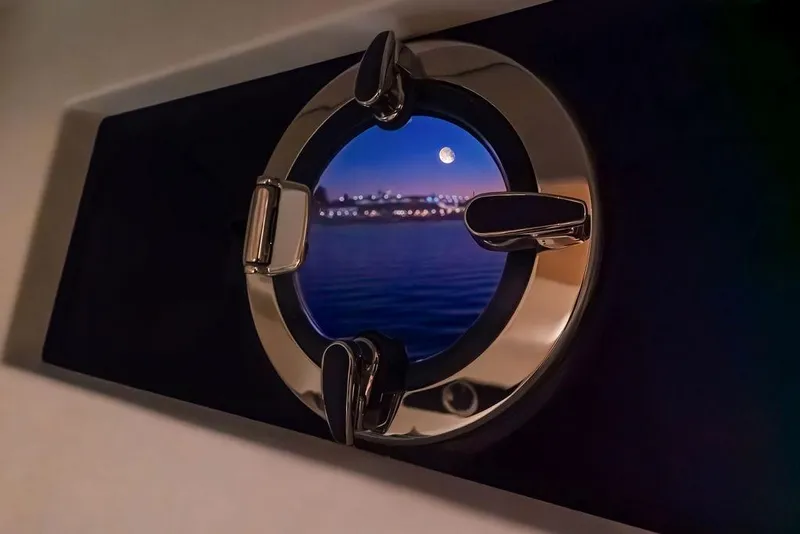 Slide: The Image of Porthole view from 2023 Pardo Yachts Endurance 60, showcasing moonlit waterfront scenery. - 38