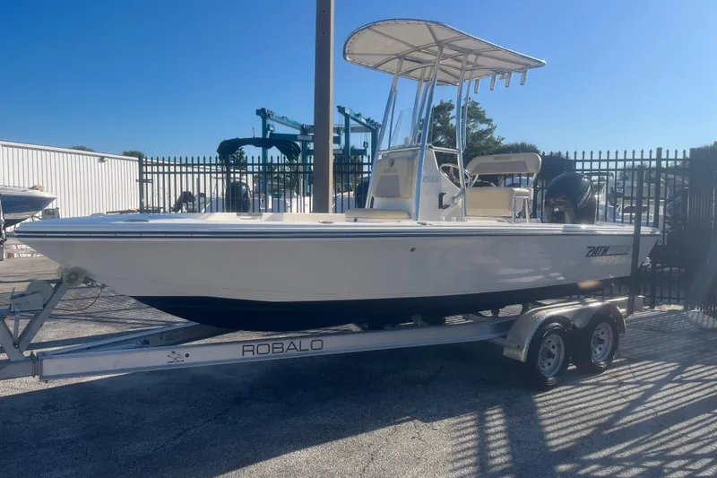 Slide: The Image of Pathfinder 2005 TRS boat on Robalo trailer, parked outdoors, 2022 model. - 2