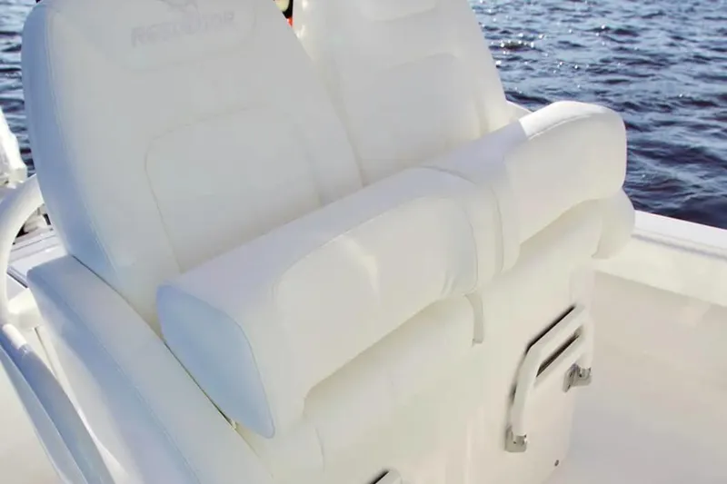 Slide: The Image of 2026 Regulator 26XO boat with white cushioned seating on a sunny day. - 3