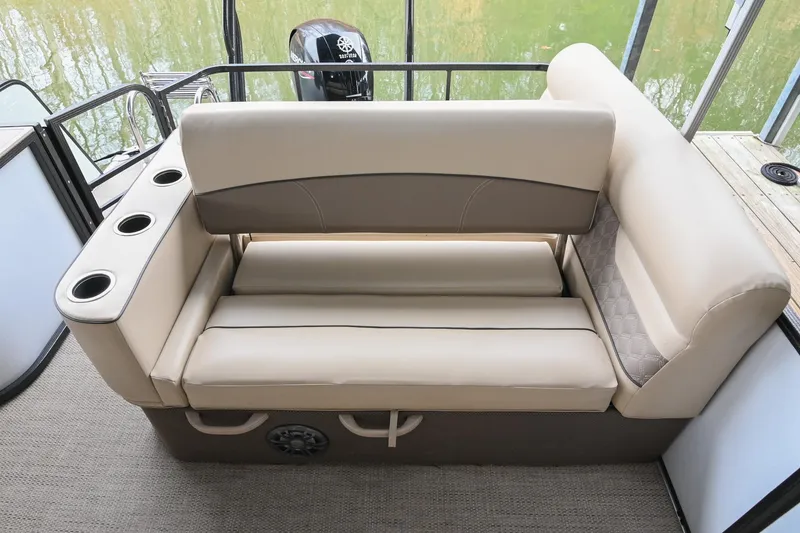 Slide: The Image of 2022 Crest Classic DLX 220 boat interior with beige seating and cup holders. - 15