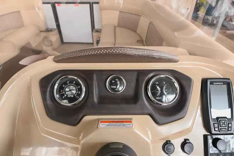 Slide: The Image of Dashboard of 2022 Crest Classic DLX 220 boat with gauges and Garmin device. - 22