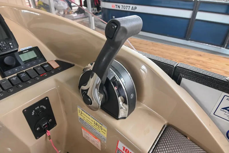 Slide: The Image of Control panel of 2022 Crest Classic DLX 220 boat with throttle lever and switches. - 24
