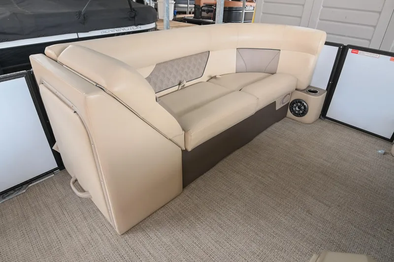 Slide: The Image of 2022 Crest Classic DLX 220 boat interior with beige seating and speaker system. - 29