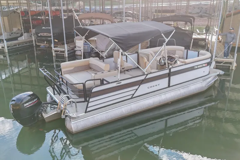Slide: The Image of 2022 Crest CLASSIC 220 SLC pontoon boat docked with Mercury outboard motor. - 3