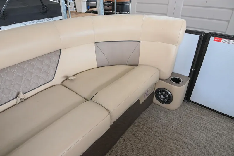 Slide: The Image of 2022 Crest Classic DLX 220 boat interior with beige seating and speaker. - 31