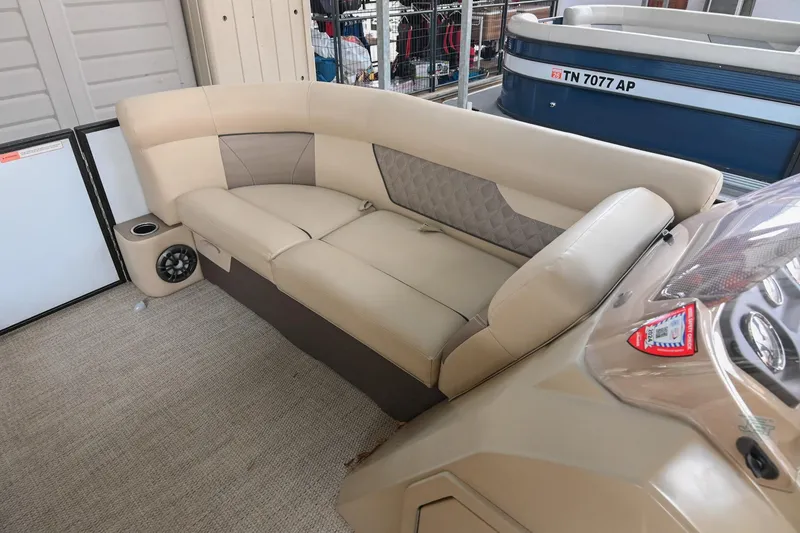 Slide: The Image of 2022 Crest Classic DLX 220 boat interior with beige seating and speaker system. - 32