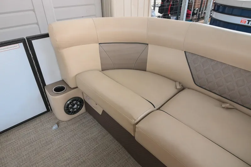 Slide: The Image of 2022 Crest Classic DLX 220 boat interior with beige seating and built-in speaker. - 34