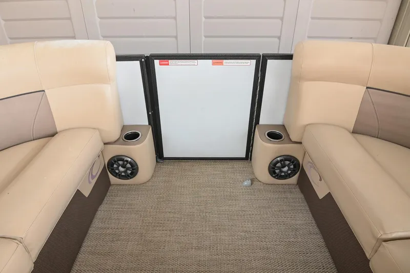 Slide: The Image of Interior of 2022 Crest Classic DLX 220 pontoon boat with beige seating and speakers. - 35
