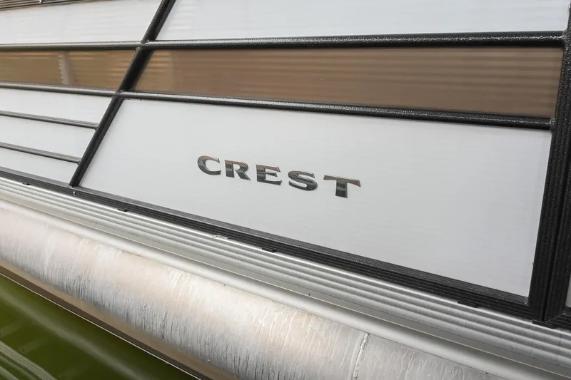 Slide: The Image of 2022 Crest Classic DLX 220 boat exterior with logo detail. - 36