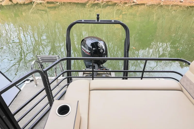 Slide: The Image of 2022 Crest Classic DLX 220 pontoon boat with Mercury outboard motor on a calm lake. - 7