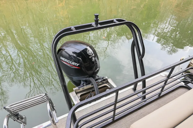Slide: The Image of 2022 Crest Classic DLX 220 pontoon boat with Mercury outboard motor on calm water. - 8